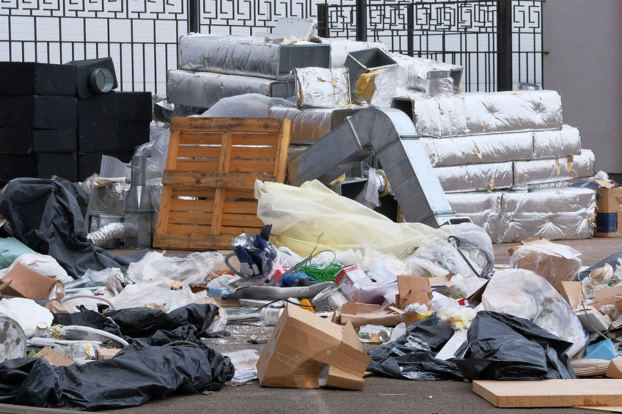 Construction garbage, cardboard, polyethylene after building repair. Removal of debris. Bunch of trash.